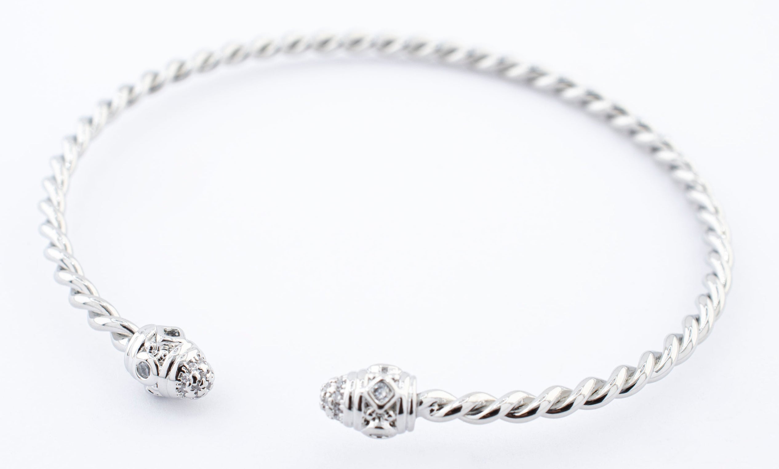 BRAZALETE TORCIDO PUNTA CIRCULOS ZIRCONIAS CHAPA DE RODIO