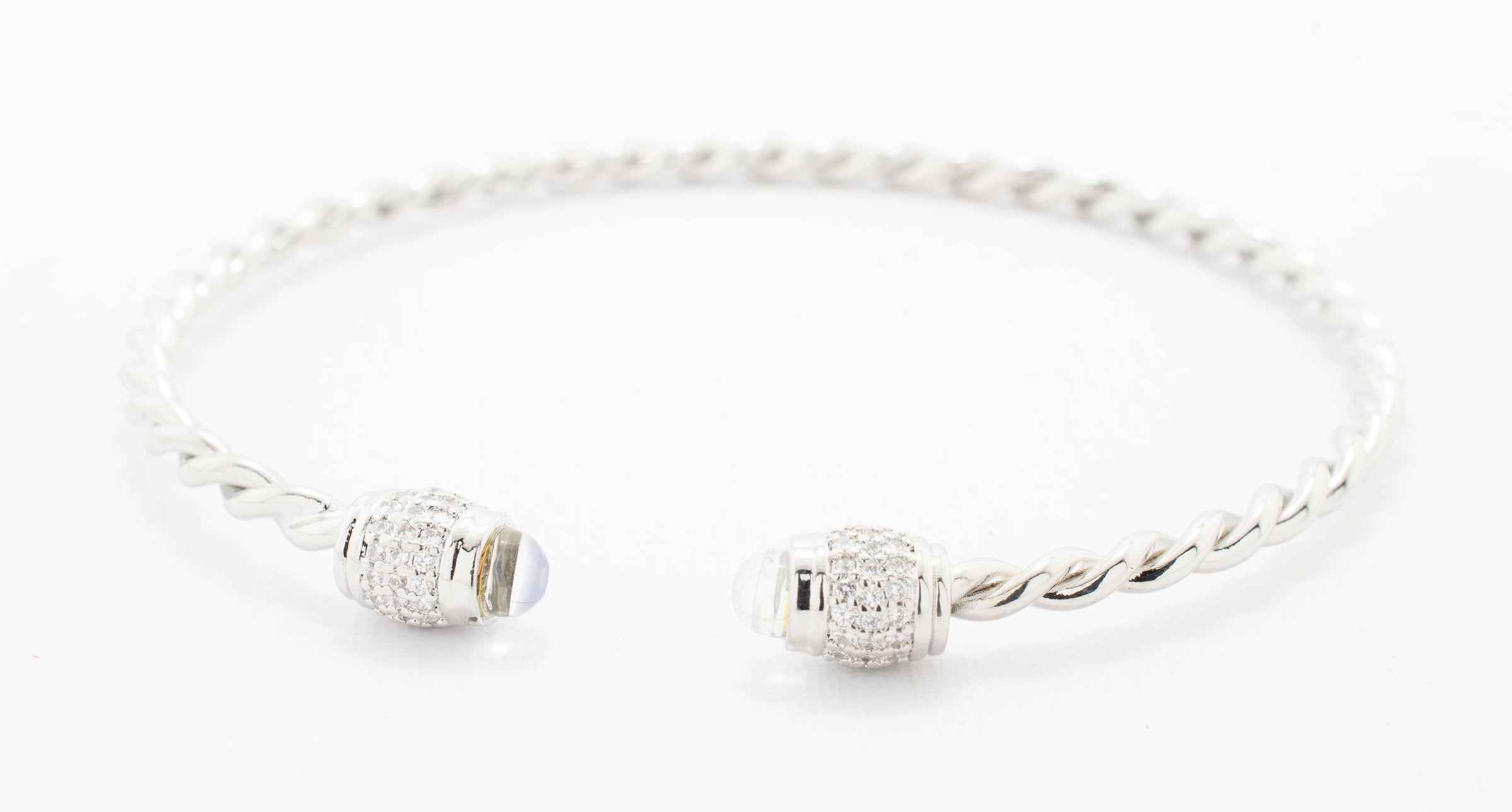 BRAZALETE TORCIDO PUNTA BARRIL ZIRCONIAS CHAPA DE RODIO