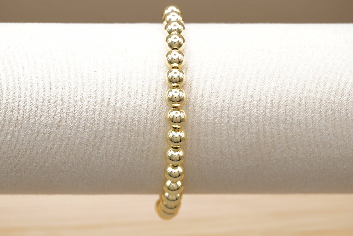 PULSERA BOLITA 6MM DORADO  ACERO