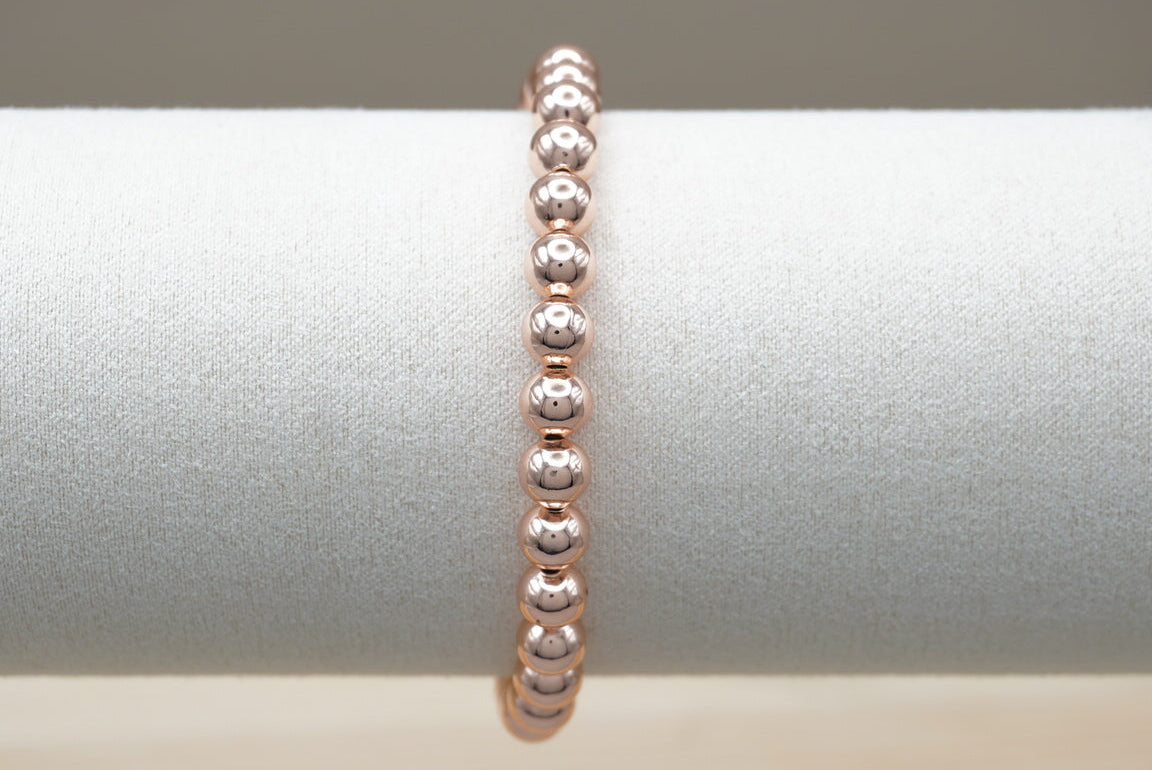 PULSERA BOLITA 6 MM ROSA ORO LAMINADO